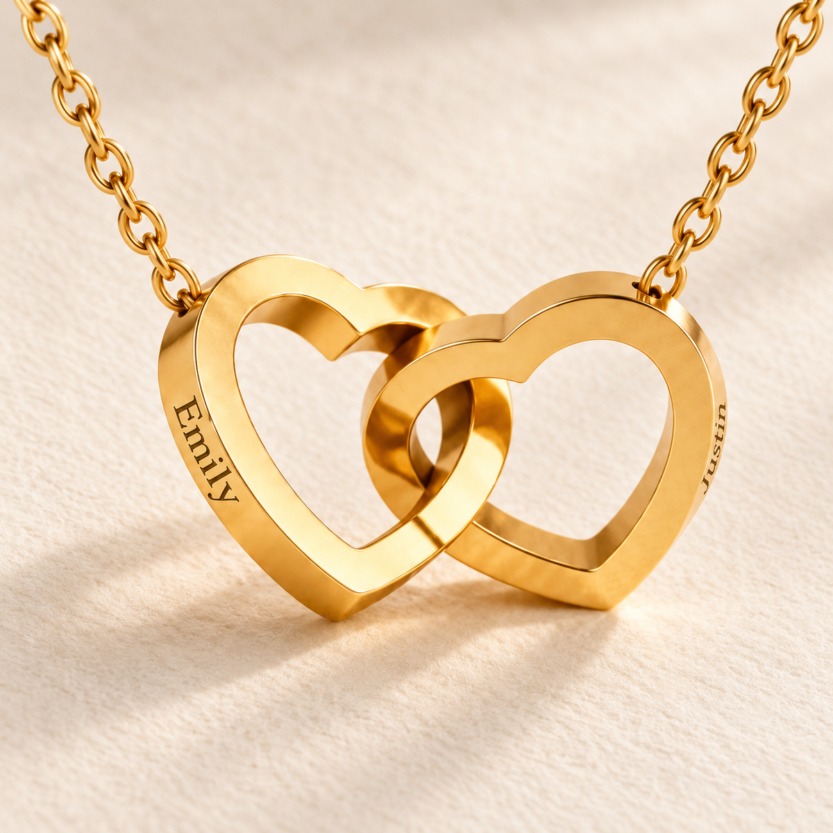 Interlinked gold heart necklace with Emily and Justin engraved on the lateral edges